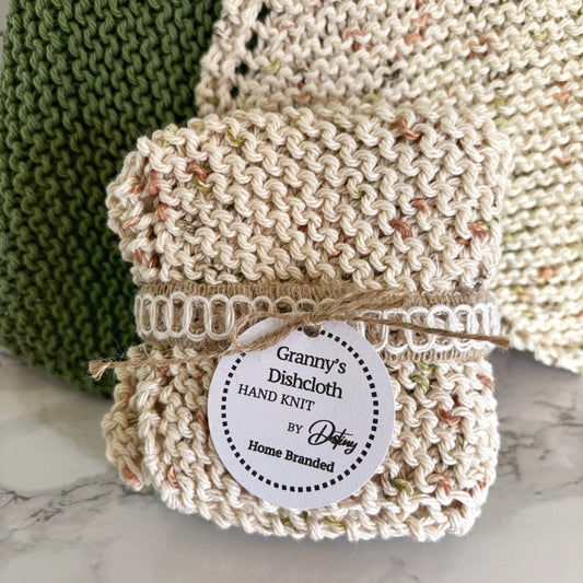 Knitted dishcloth with a label on a marble surface