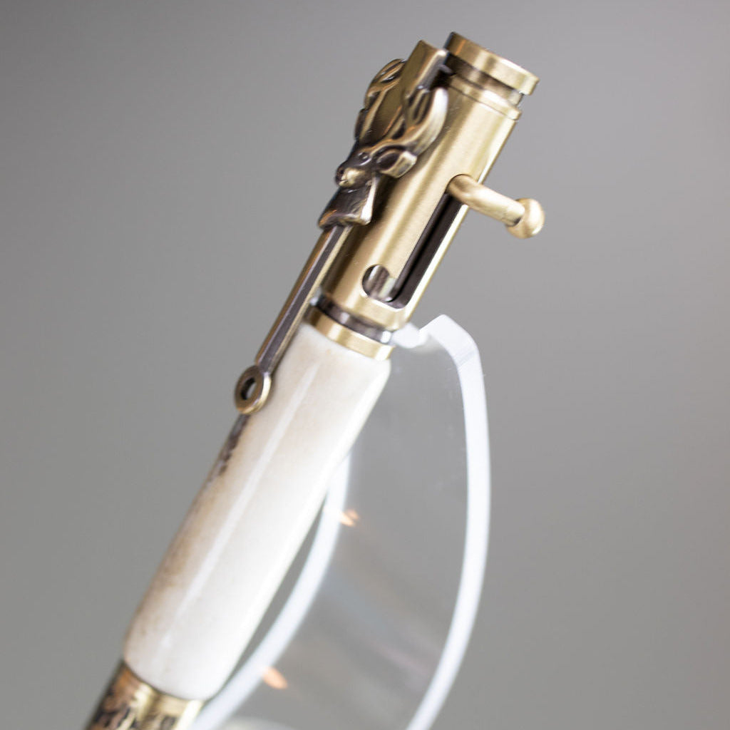 Decorative pen with gold and white design on a gray background