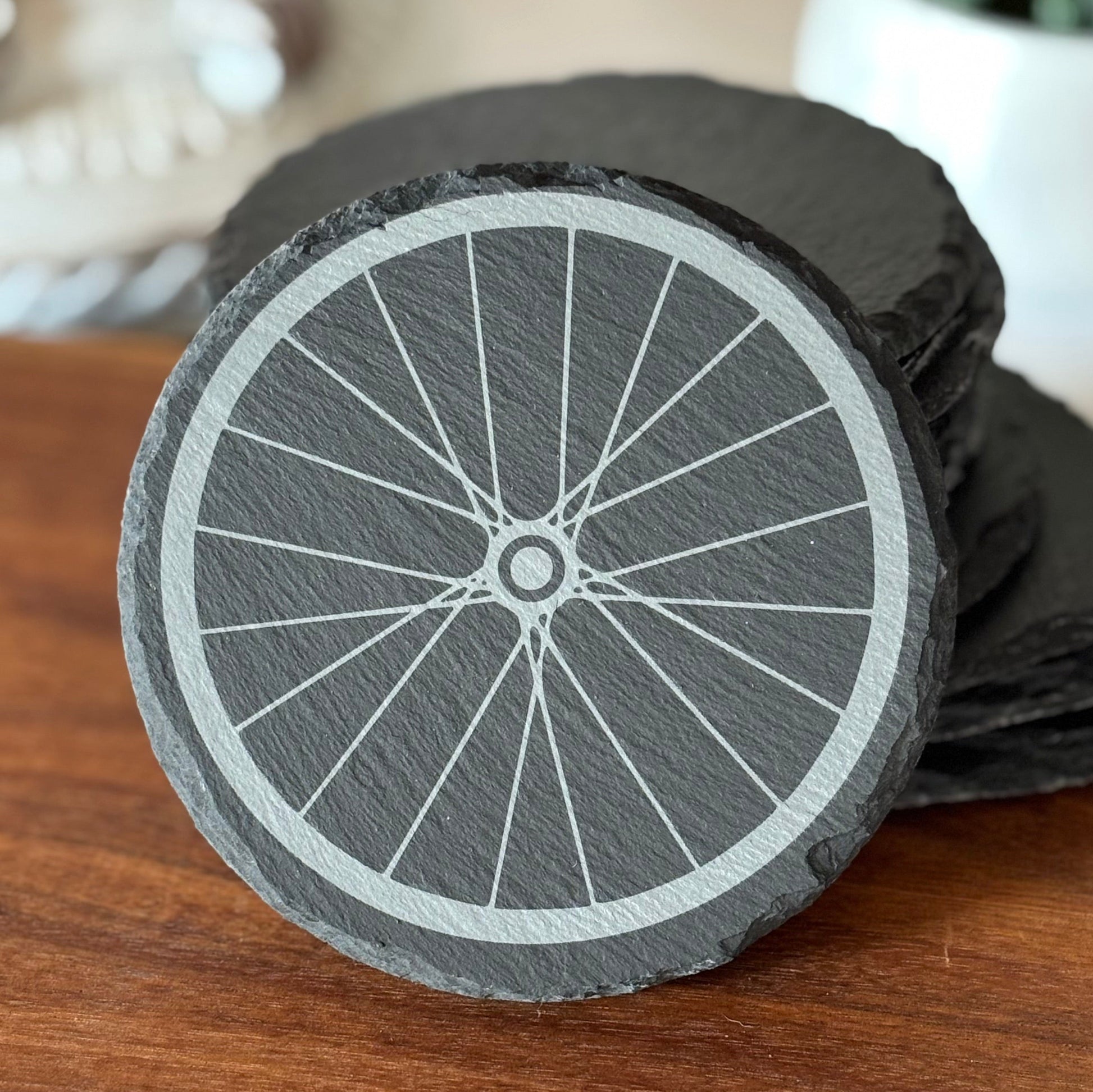 black slate coaster with a bike wheel design