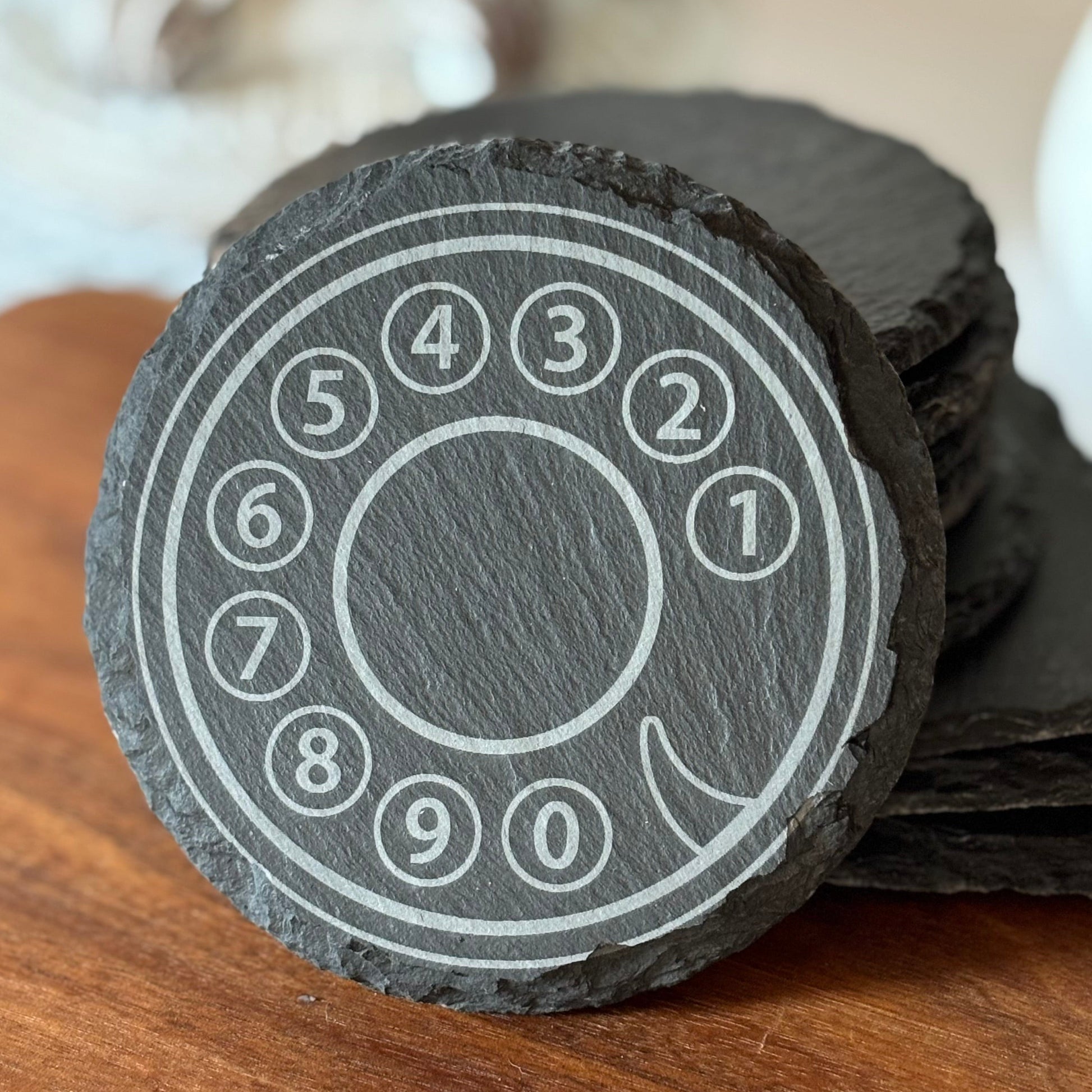 Black slate coaster with a rotary phone design