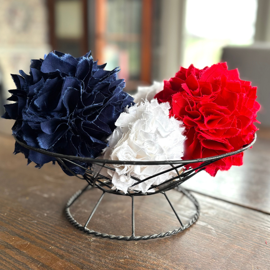 100% cotton rag balls in red white and blue on a wire basket for a centerpiece